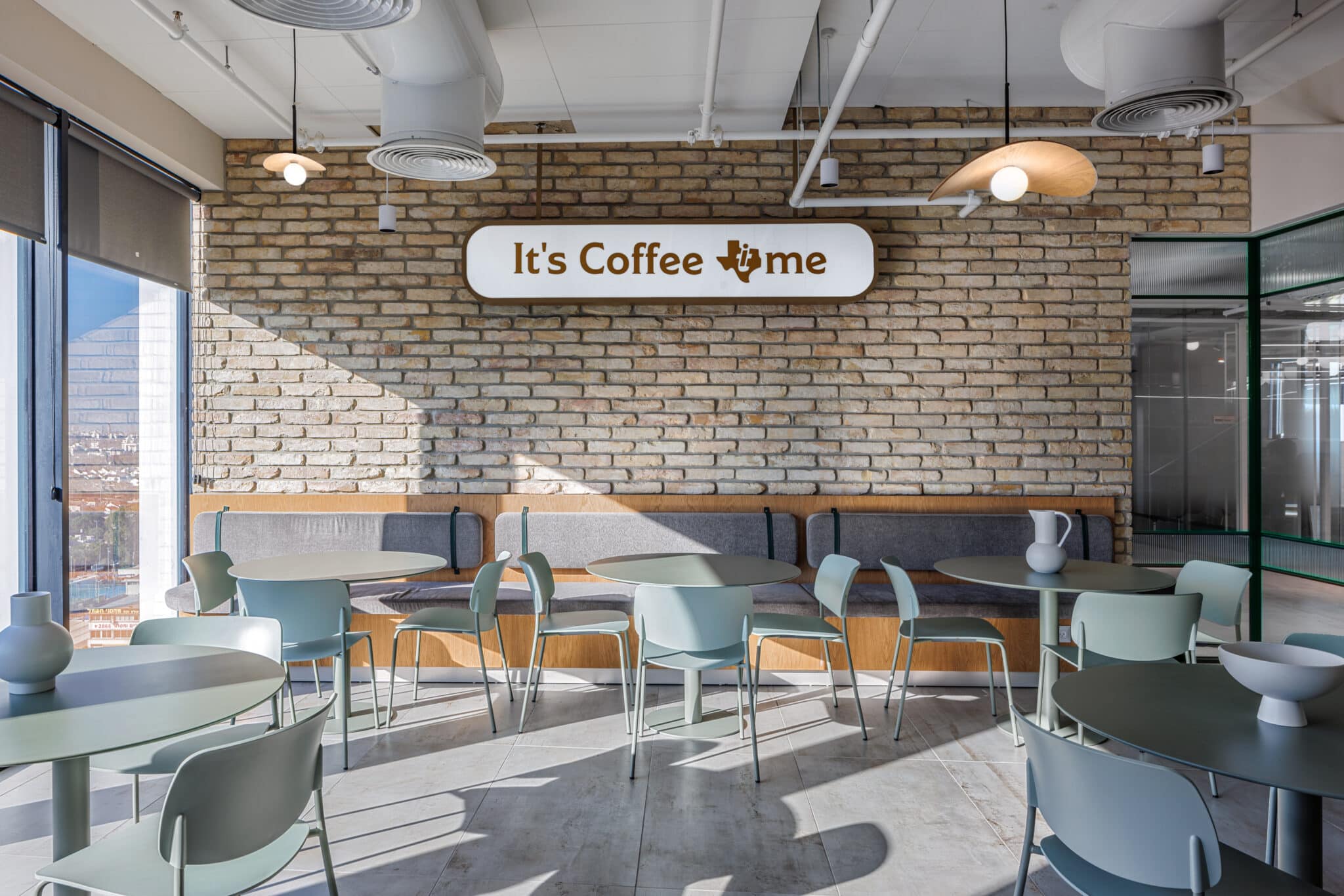 Its Coffee Time sign with a 3D Texas symbol on an exposed brick wall
