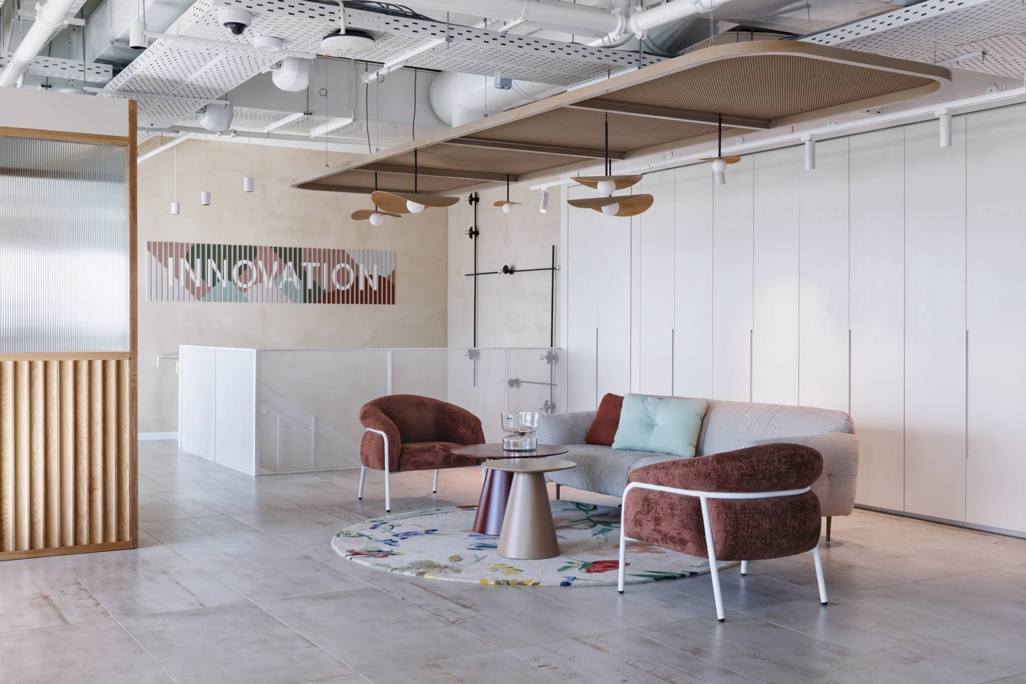INNOVATION wall graphic in coloured stripes above a lounge