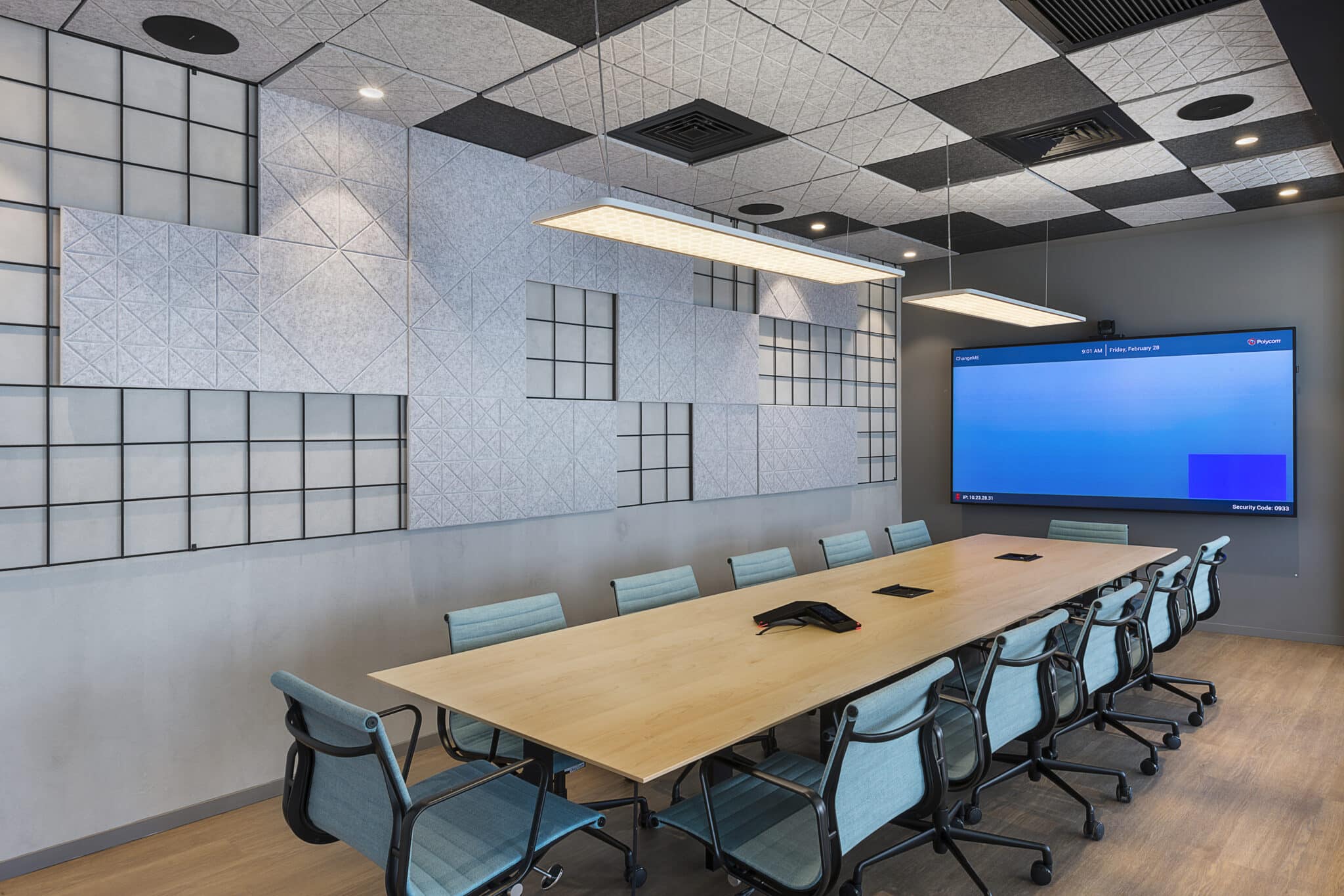 Grey acoustic felt panels on the wall and ceiling of a meeting room