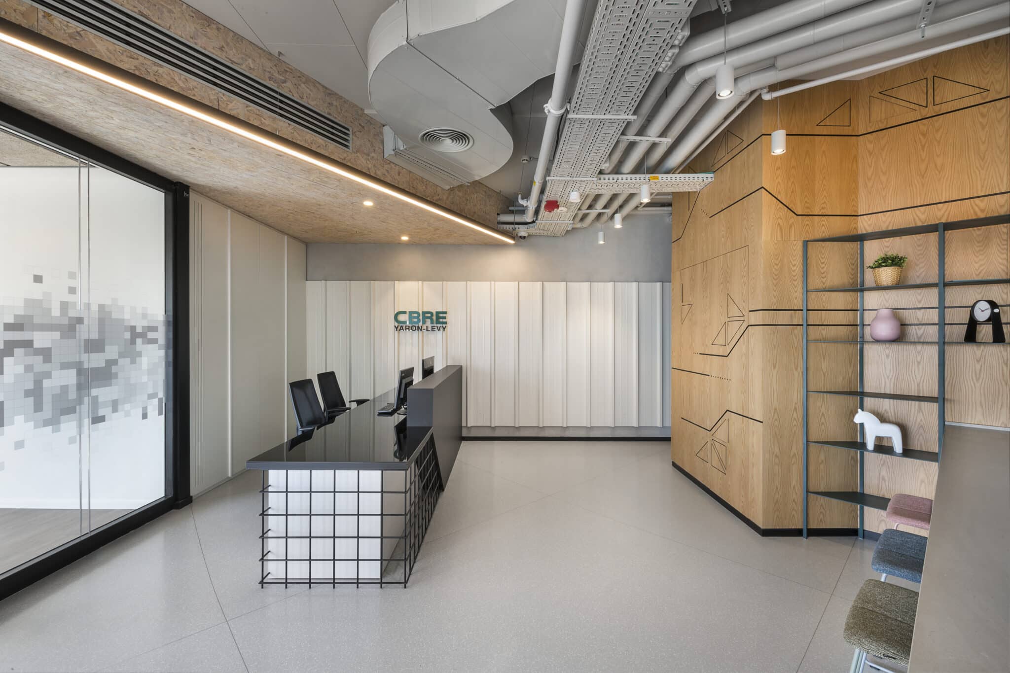 3D CBRE Yaron-Levy logo on the reception wall with line drawings on wood