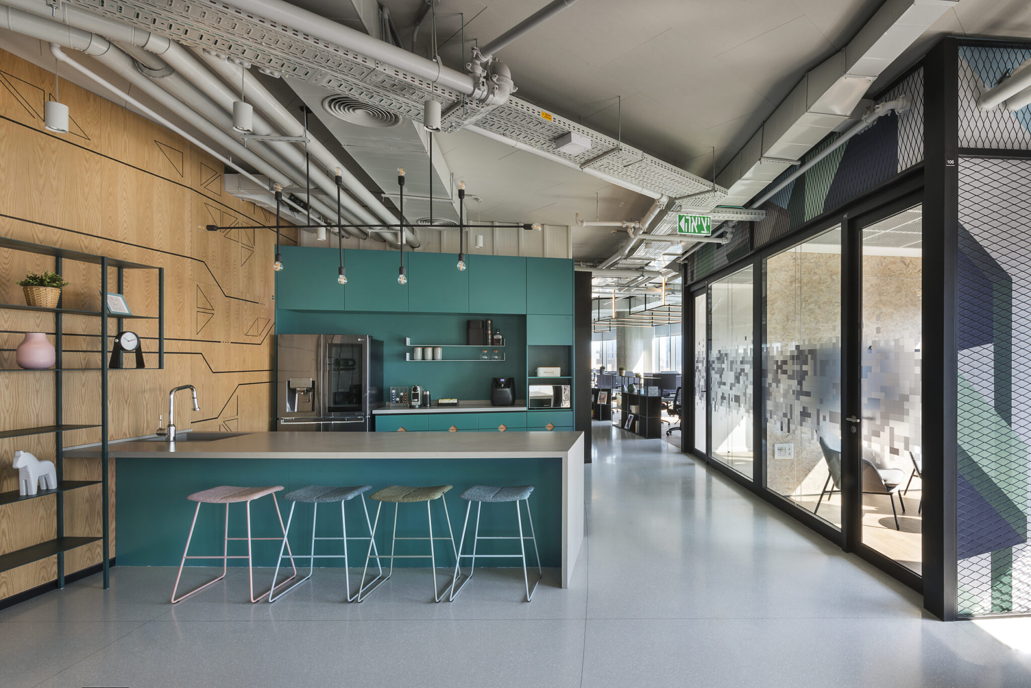 Black line drawings on a wood wall and printed glass by an office kitchen