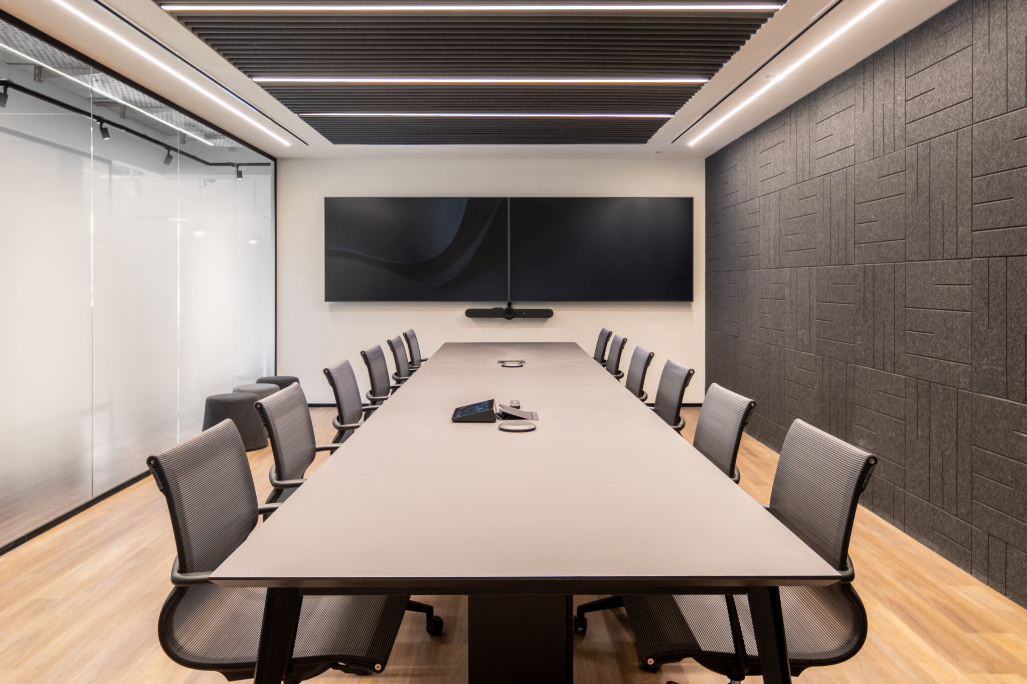 Dark textured acoustic panel wall in a large meeting room