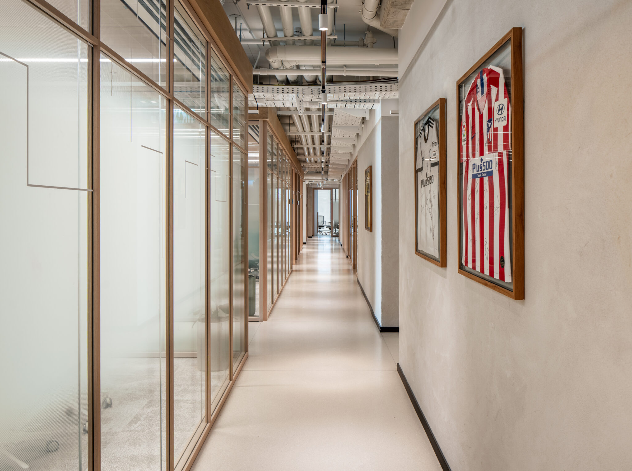 Line graphics on office glass with framed football shirts opposite