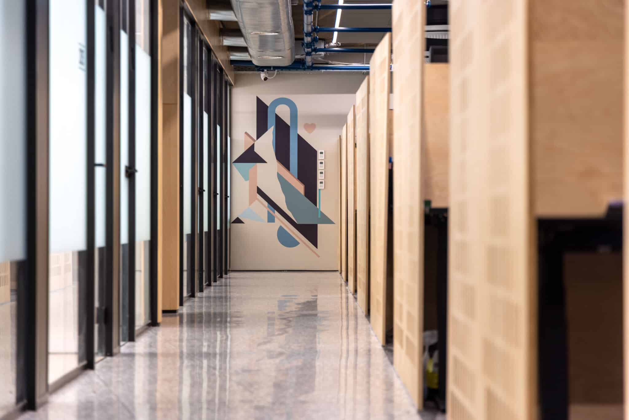 Geometric wall graphic in blue and black at the end of a corridor