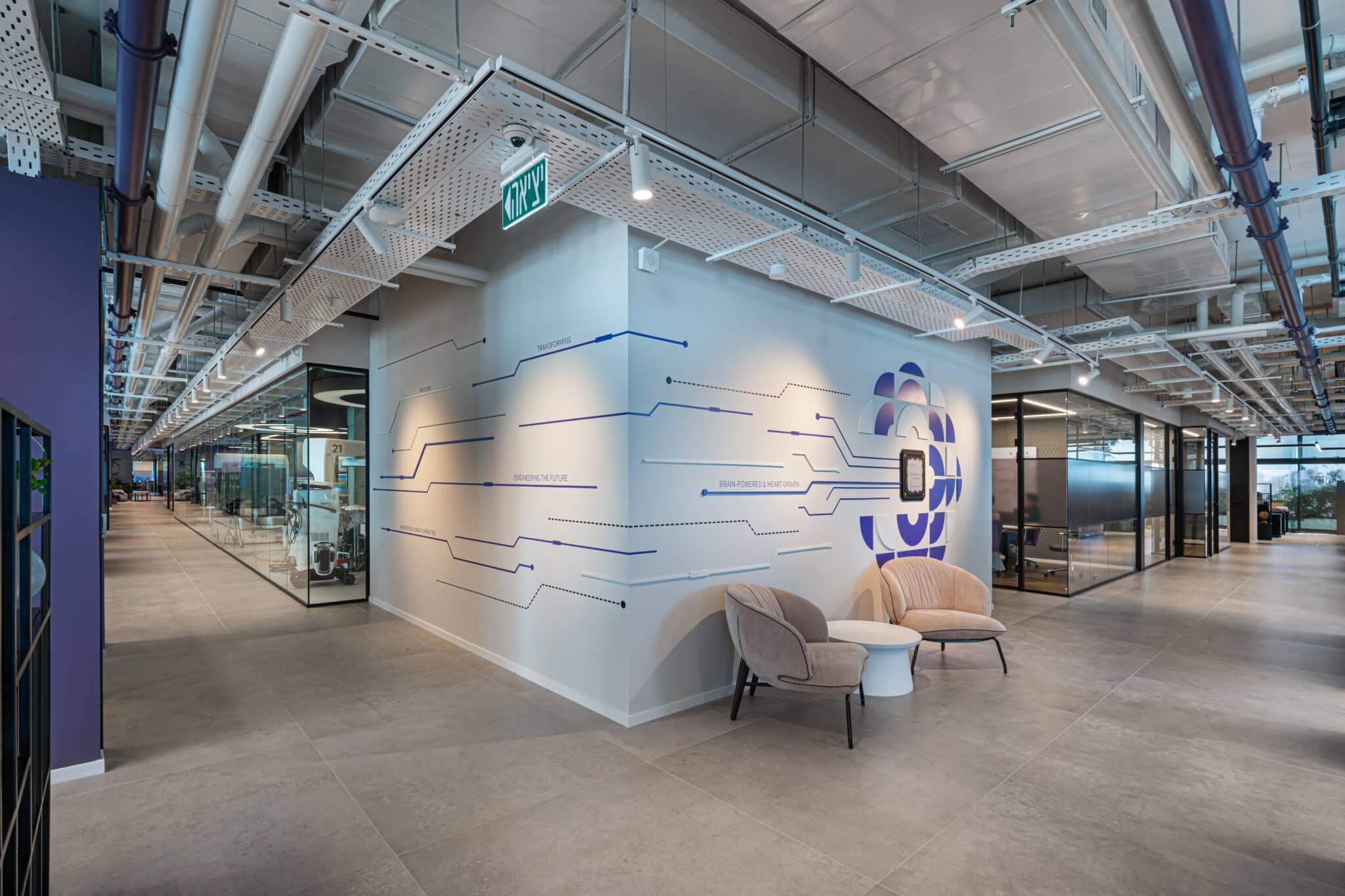 Blue circuit line wall graphic wrapping an office corner