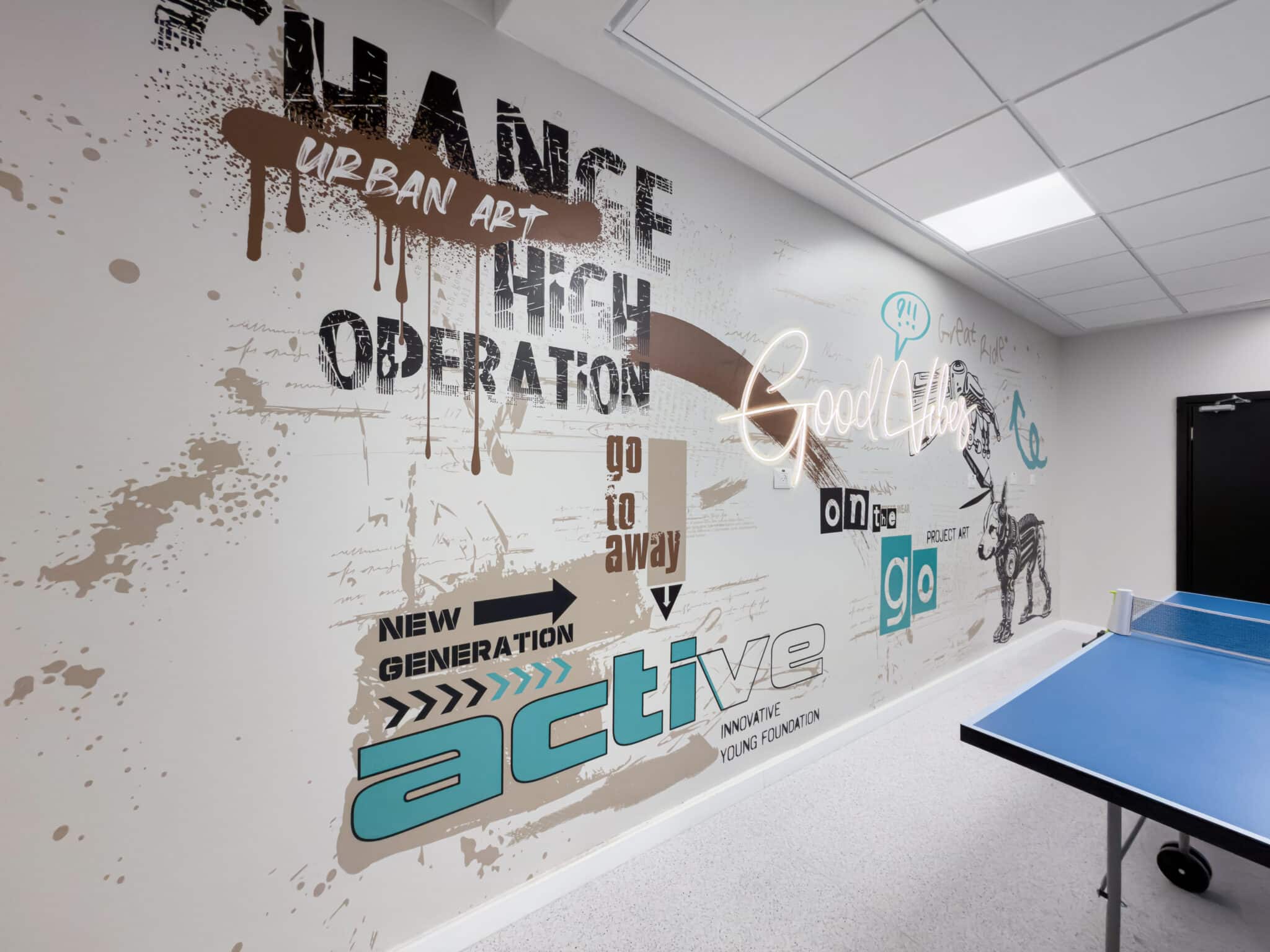 Urban art style wall mural beside a table tennis table