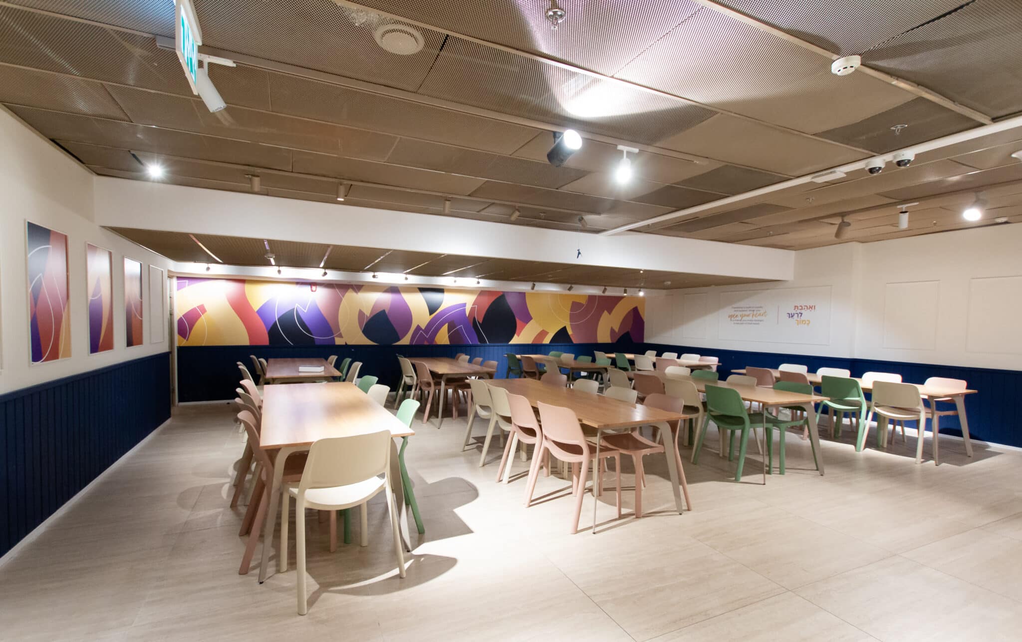 Colourful abstract wall mural above dining tables