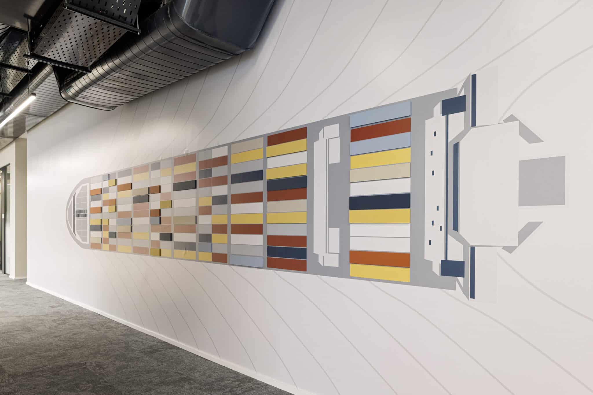 Container ship wall graphic in coloured blocks along a corridor