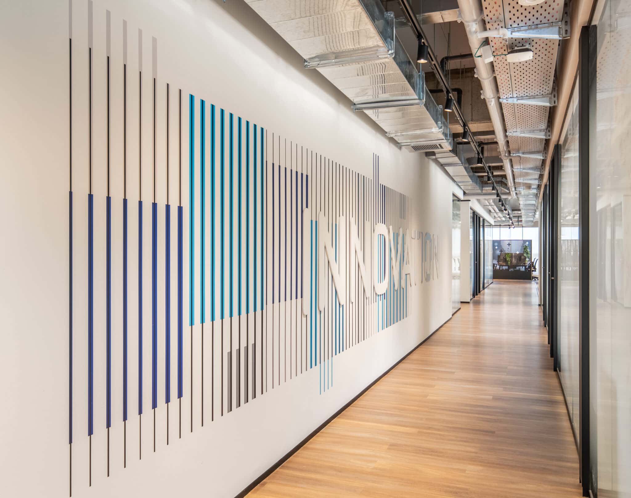 INNOVATION wall graphic formed from a gradient field of vertical stripes