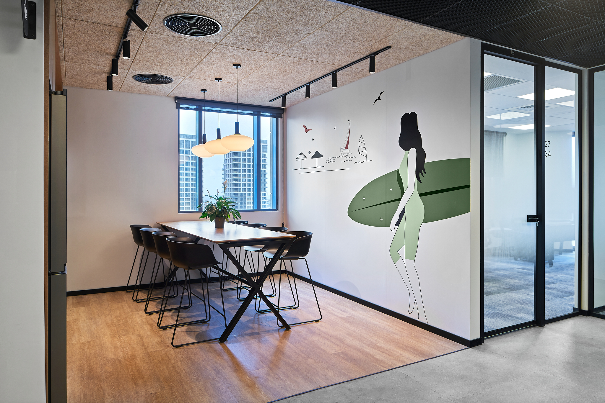 Surfer wall graphic on a corner wall beside a meeting room