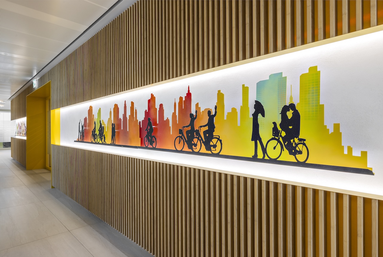 Backlit city skyline graphic set into a wood slat wall