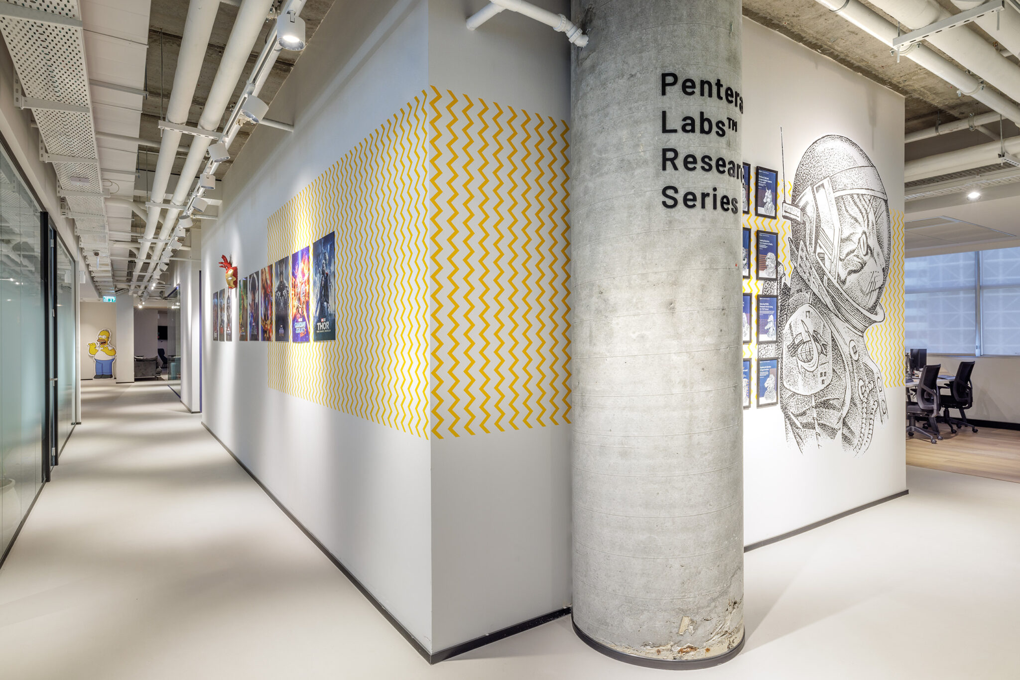 Yellow zigzag wall graphic and astronaut line drawing in a corridor