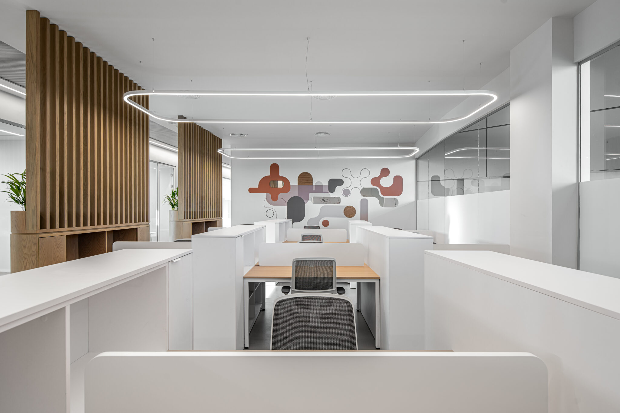 Abstract shape wall graphic at the end of a white open office