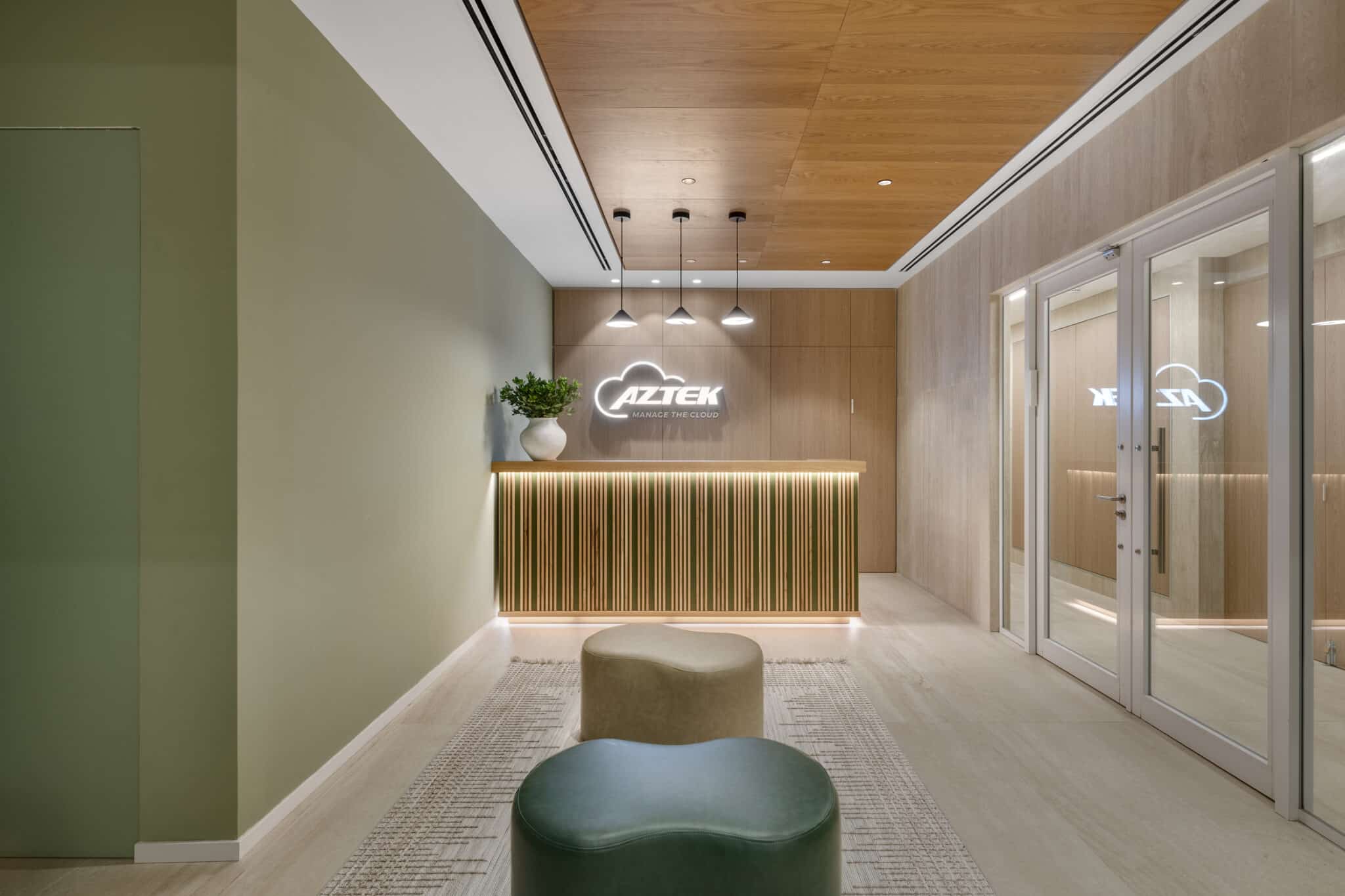 AZTEK cloud logo lit above a fluted reception counter