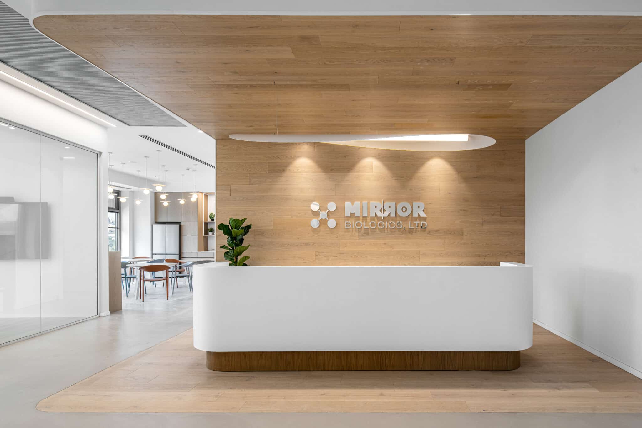 Mirror Biologics 3D logo on a wood reception wall