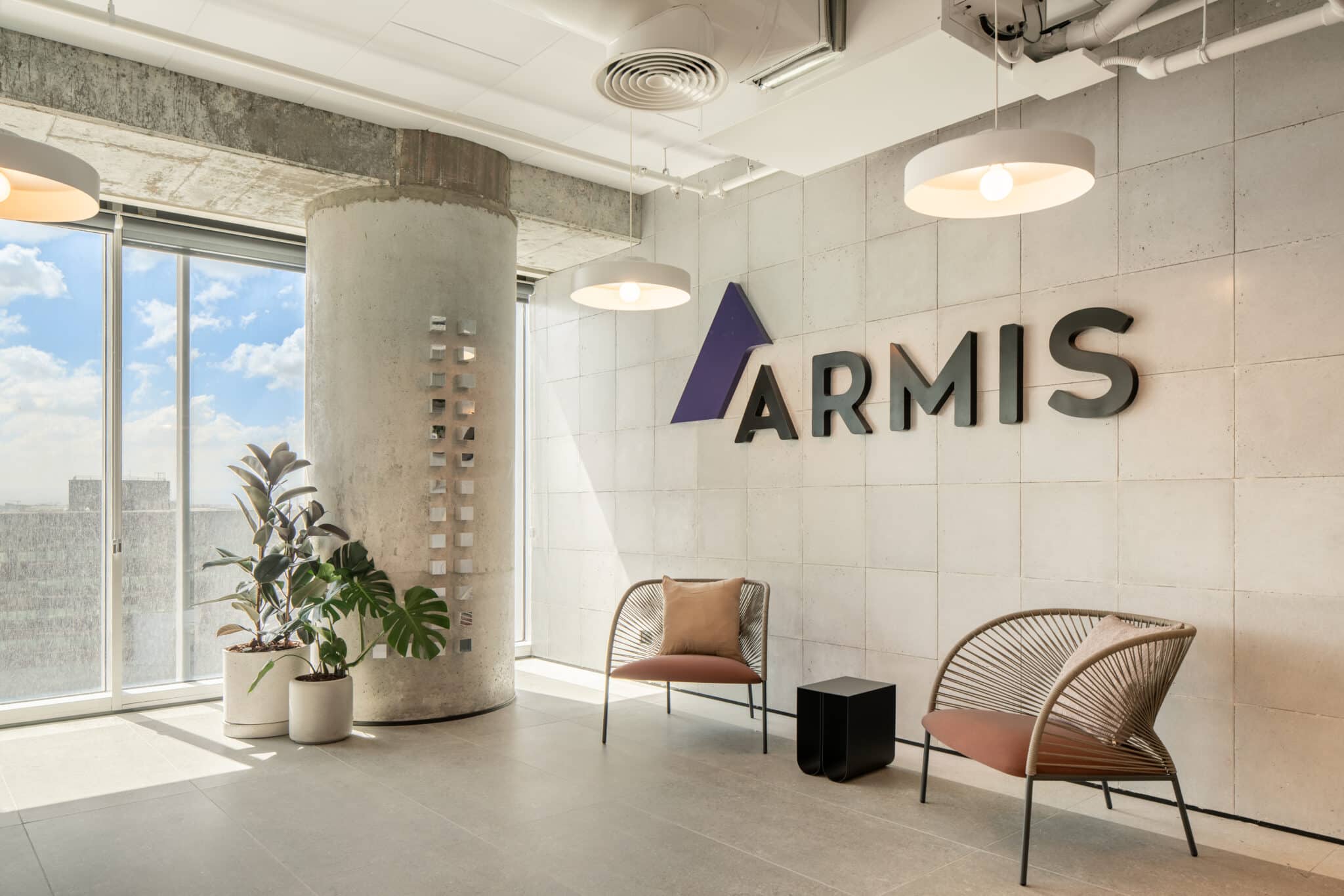 ARMIS 3D logo on a concrete tile reception wall
