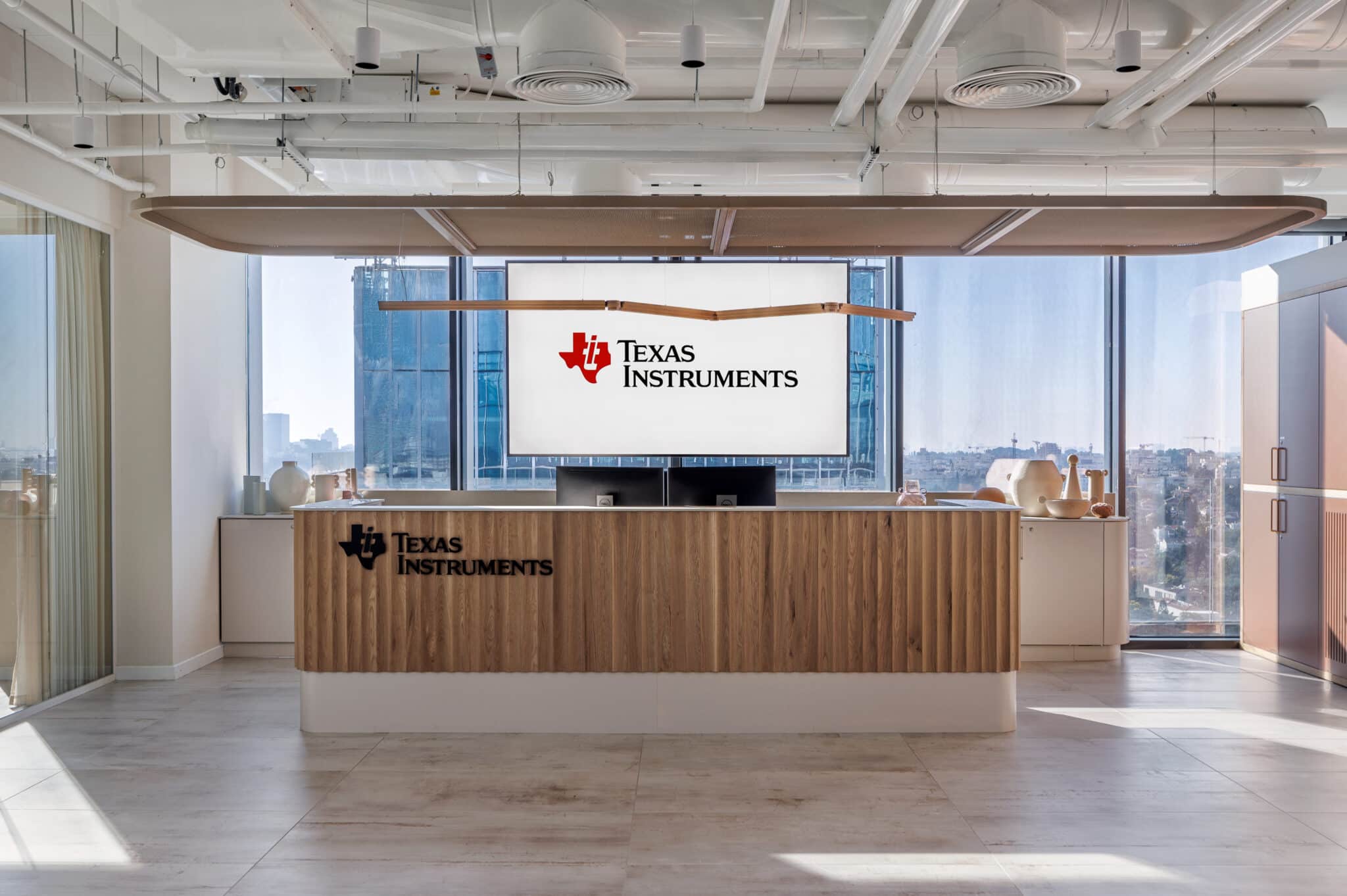 Texas Instruments logo on the reception wall and the fluted desk front