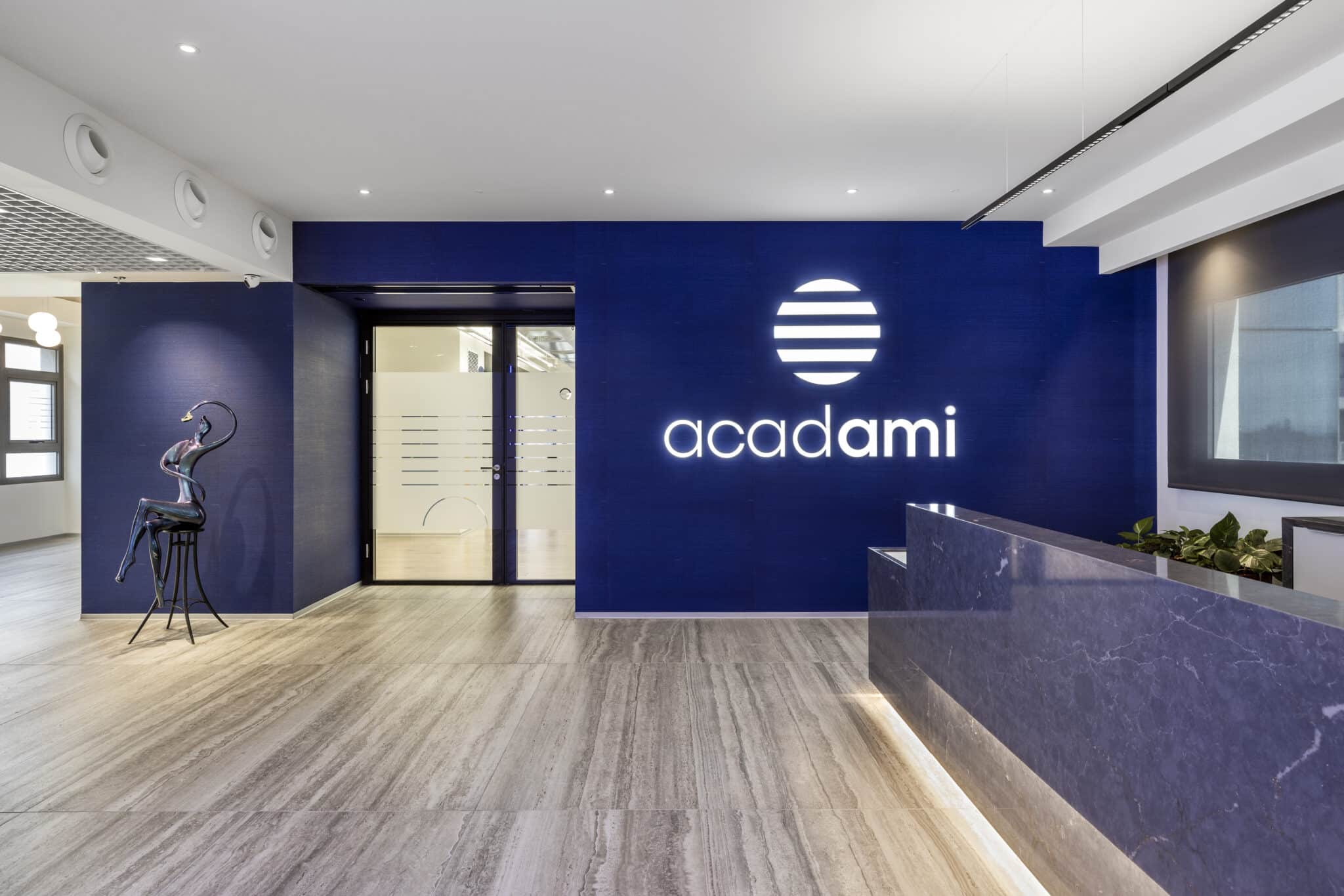 acadami logo in white letters on a deep blue reception wall