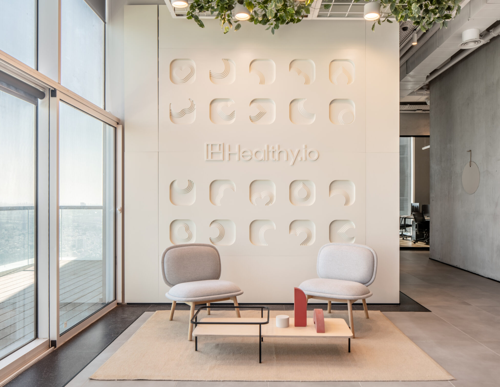 Healthy.io logo on a white wall of recessed shape reliefs