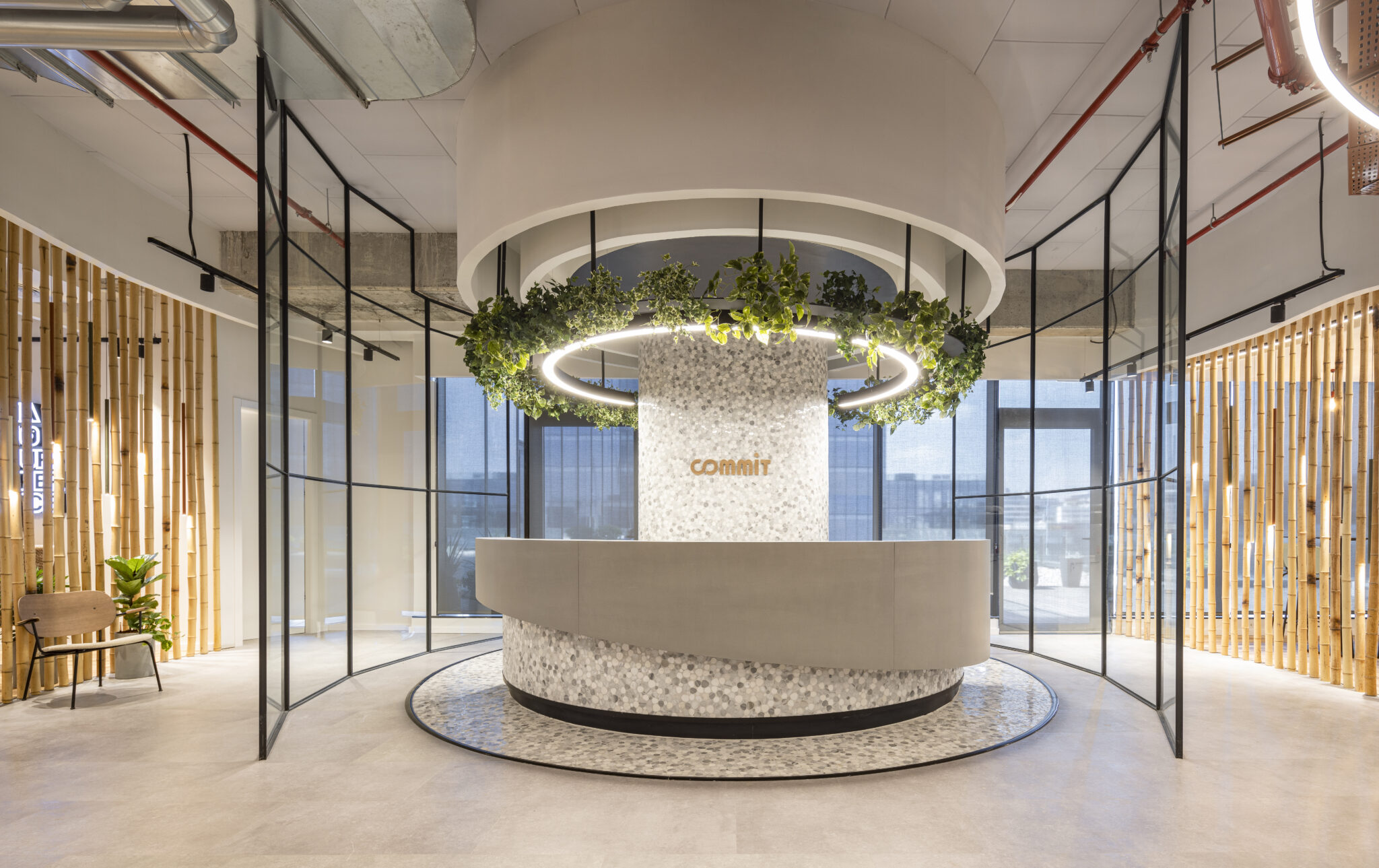COMMIT logo on a round reception counter under a lit ring