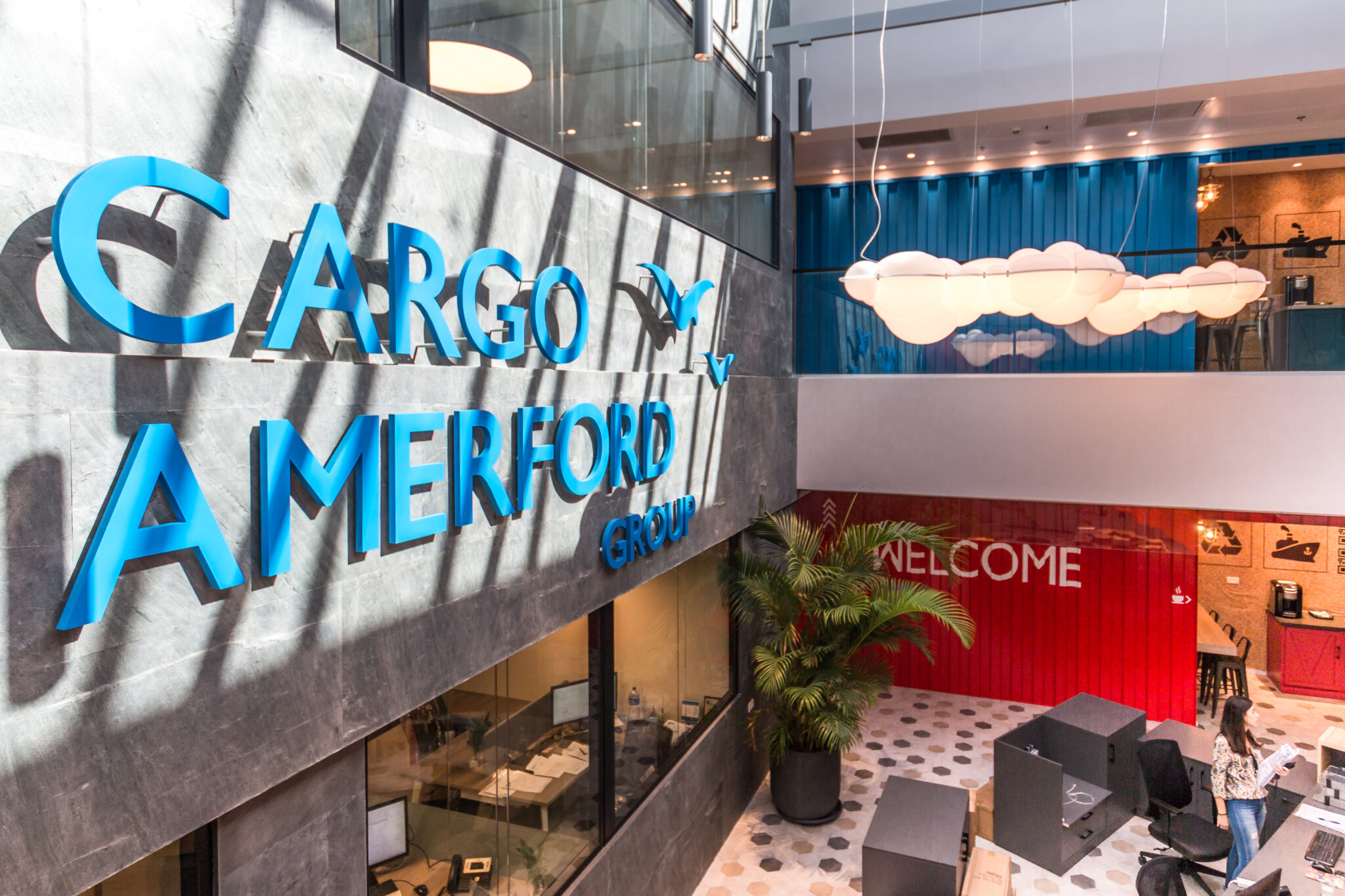 CARGO AMERFORD blue 3D logo letters on a concrete atrium wall