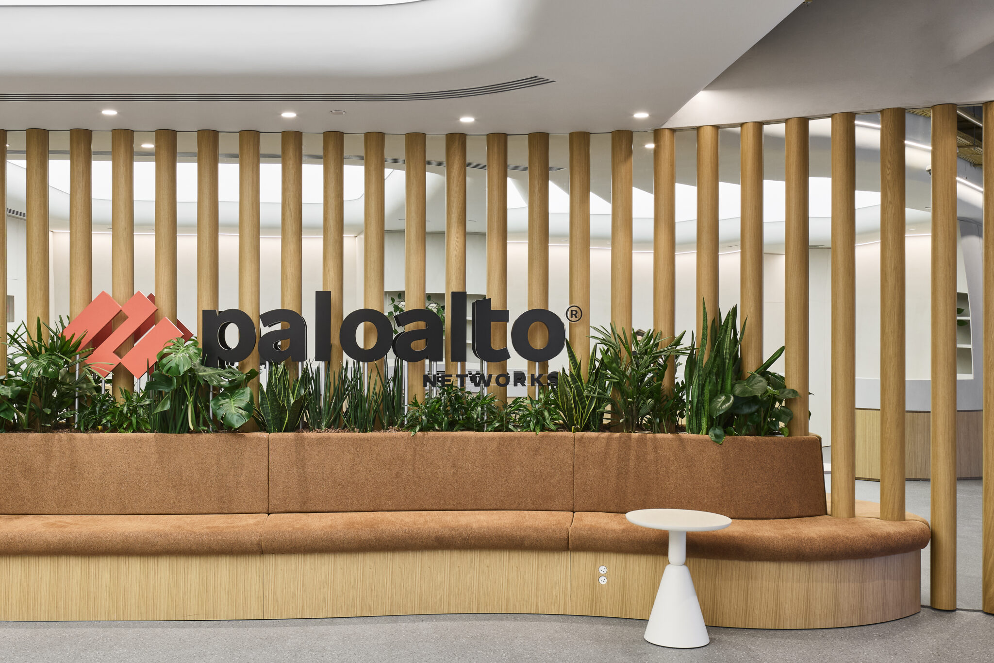 paloalto NETWORKS 3D logo behind a row of wood columns