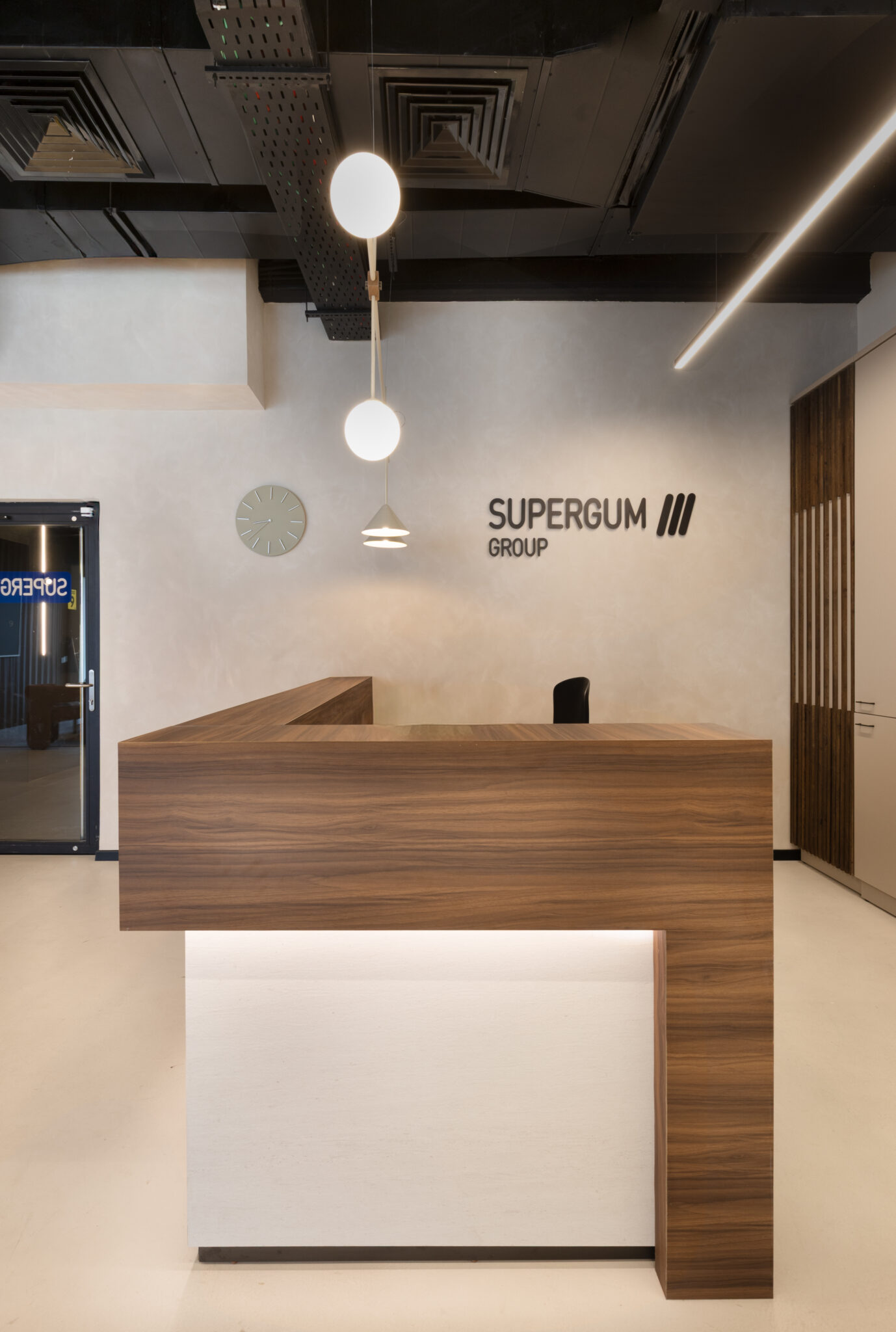 SUPERGUM GROUP 3D logo letters on a reception wall