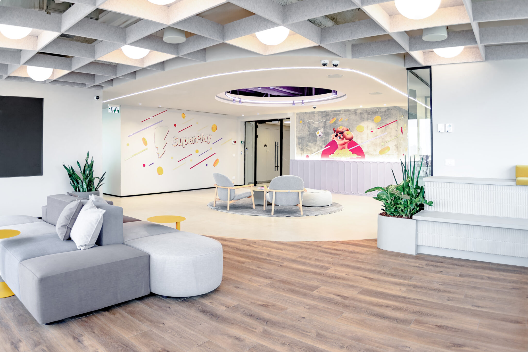 SuperPlay logo wall graphic and character graphic in a bright lounge