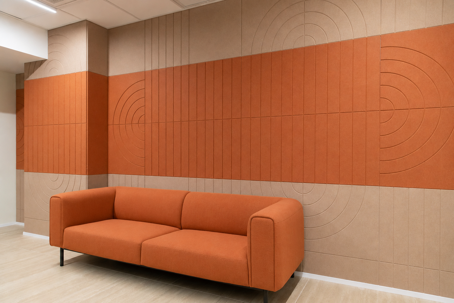Acoustic panel wall in orange and sand with concentric routed circles